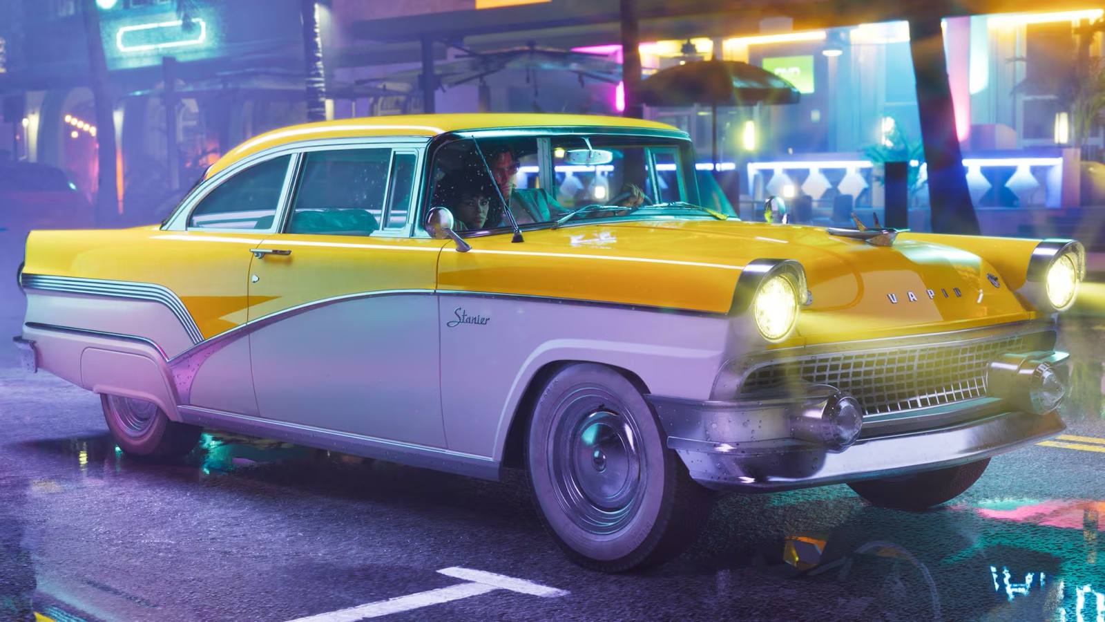 A classic two-tone coupe in yellow and cream parked outdoors